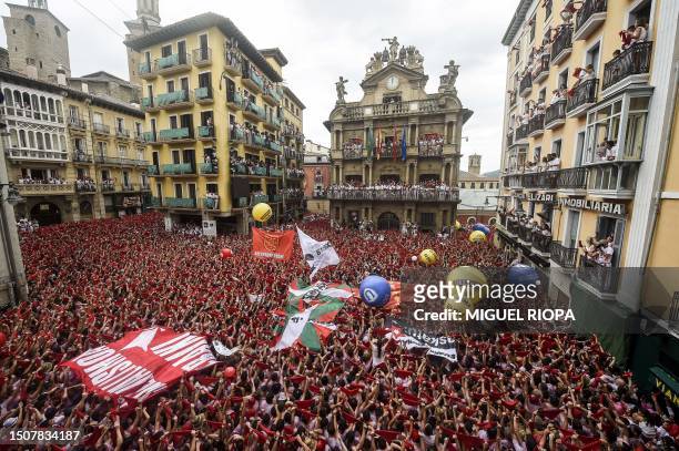 Participants wave their red scarves during the "Chupinazo" opening ceremony to mark the kick-off of the San Fermin bull Festival outside the Town...