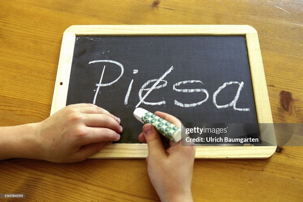 Symbolic photo to the topic: PISA - study, Our photo shows a child which has written " PIESA " and is now crossing out the " E ".