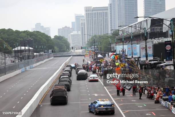 Cars sit parked on pit road during a weather delay in the NASCAR Xfinity Series The Loop 121 at the Chicago Street Course on July 01, 2023 in...