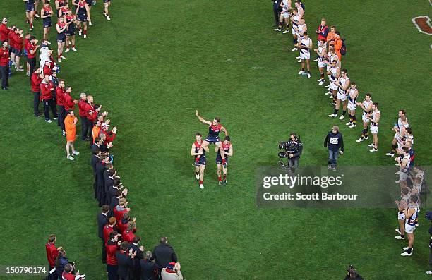 Players form a guard of honour as Brad Green of the Demons is chaired from the field after playing his last match after the round 22 AFL match...