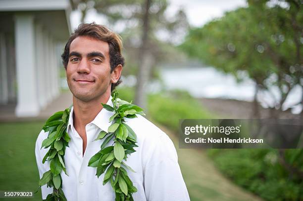 a groom smiles on his wedding day at the beach - lei day hawaii stock pictures, royalty-free photos & images