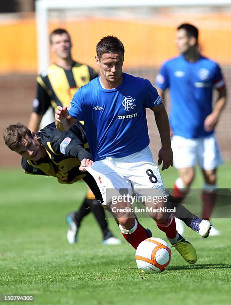 Steven Notman of Berwick Rangers competes with Ian Black of Rangers duringThe Irn-Bru Scottish Third Division match between Berwick Rangers and...