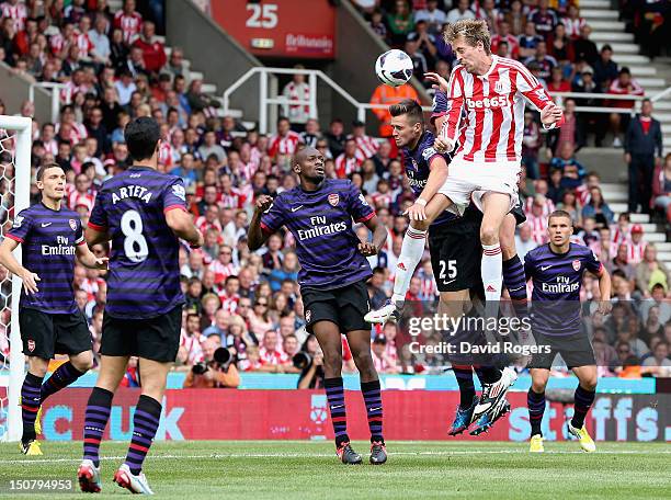 Peter Crouch of Stoke City beats the Arsenal defence to the ball during the Barclays Premier League match between Stoke City and Arsenal at the...