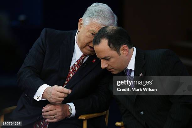 Former Mississippi Gov. Haley Barbour and RNC Chairman Reince Priebus prepare to give an interview ahead of the Republican National Convention at the...