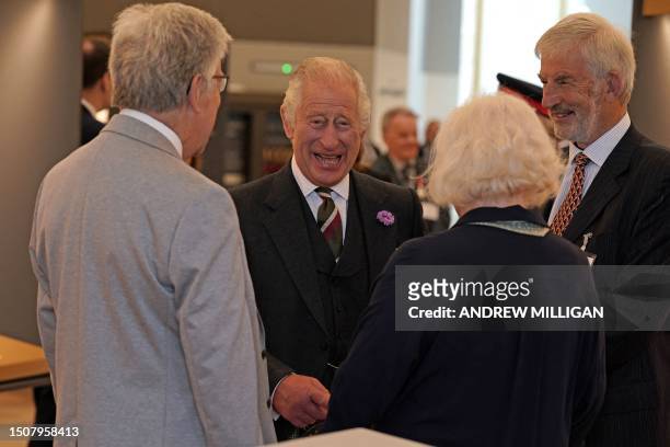 Britain's King Charles III smiles during a visit to The great Tapestry of Scotland visitor centre in Galashiels, south of Edinburgh on July 6 to mark...