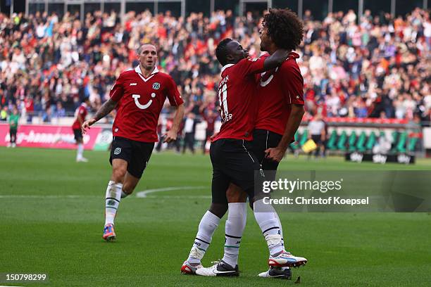 Felipe celebrates the first goal with Didier Ya Konan of Hannover during the Bundesliga match between Hannover 96 and FC Schalke 04 at AWD Arena on...