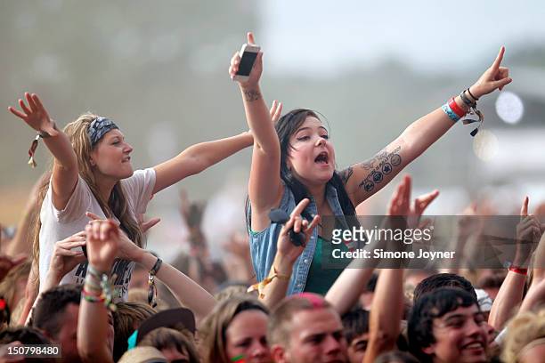 Music fans soak up the atmopshere as Bullet For My Valentine perform live on the Main Stage on Day Three during the Reading Festival 2012 at...