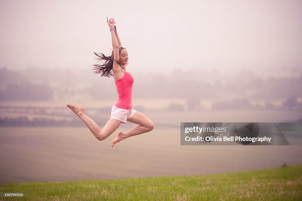 Girl Jumping in field