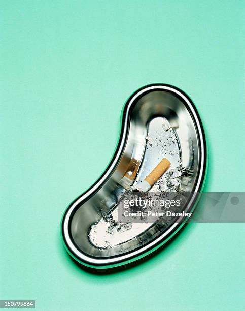 a cigarette stubbed out in a surgical dish - surgical tray stock pictures, royalty-free photos & images