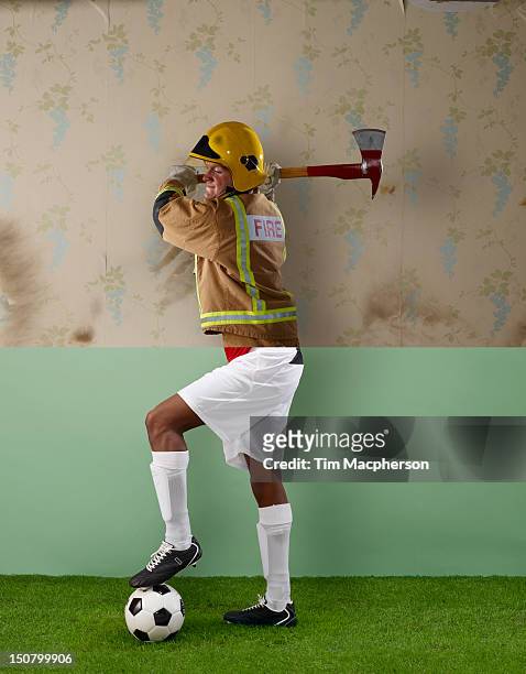 fireman top, footballer bottom - firefighter uk stock pictures, royalty-free photos & images