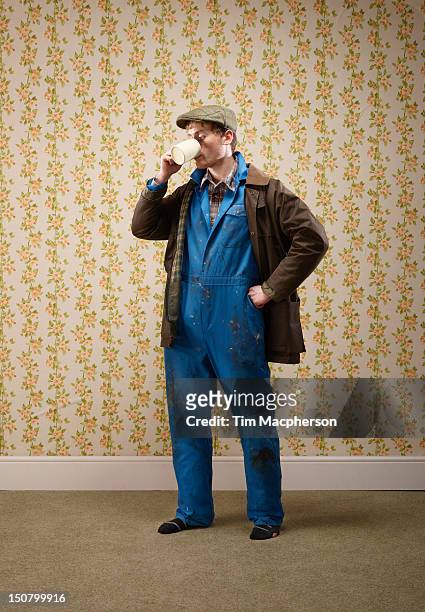 male farmer drinking from a cup - gorra plana fotografías e imágenes de stock