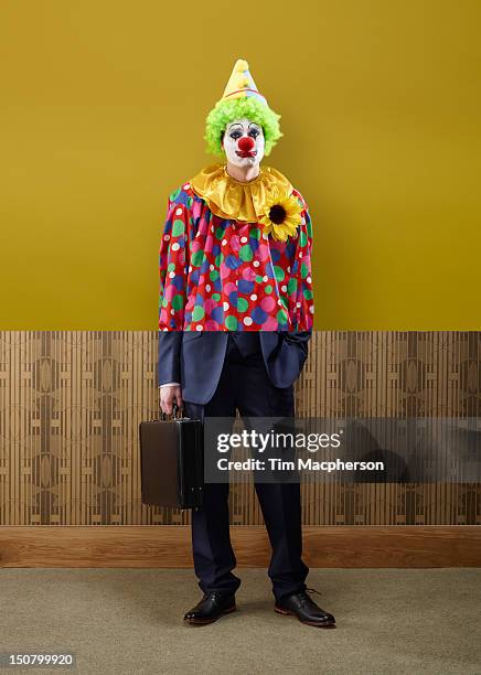 clown top, business man bottom - payaso fotografías e imágenes de stock