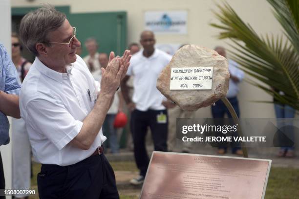 Yannick d'Escatha, President of CNES looks at a commemorative plaque and a stone from the Baikonur launch pad from which Yuri Gagarin took off in...