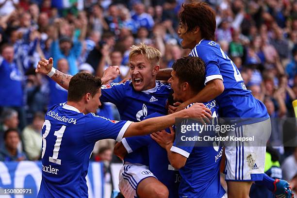 Lewis Holtby of Schalke celebrates the second goal with Julian Draxler , Roman Neustaedter and Atsuto Uchida of Schalke during the Bundesliga match...