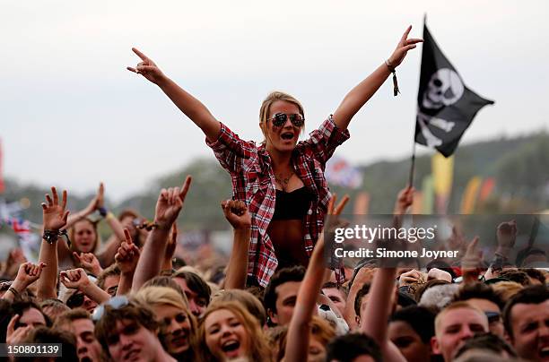 Fan soaks up the atmopshere as the Kaiser Chiefs performs live on the Main Stage on Day Three during the Reading Festival 2012 at Richfield Avenue on...