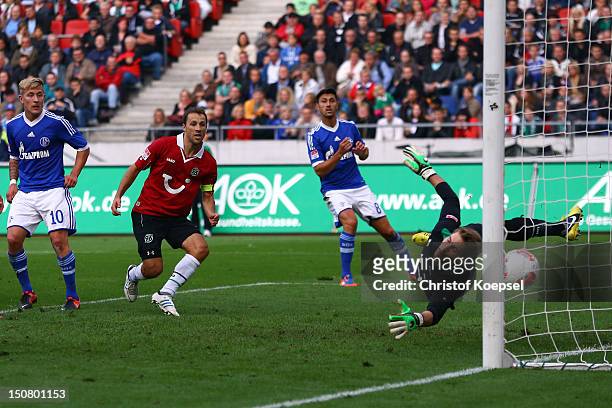 Lewis Holtby of Schalke scores the scores the second goal against Ron-Robert Zieler of Hannover during the Bundesliga match between Hannover 96 and...