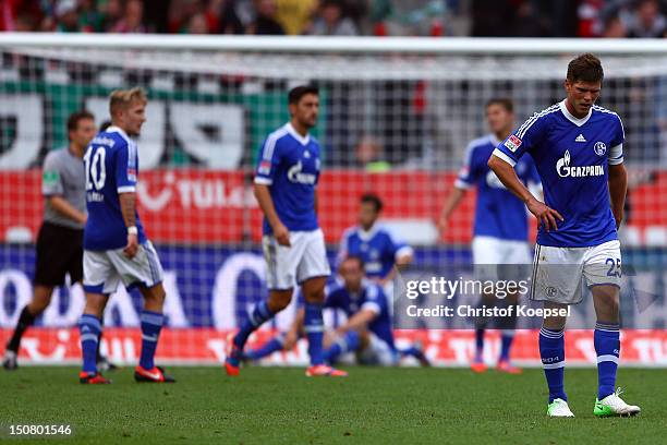 Lewis Holtby, Ciprian Marica, Roman Neustaedter and Klaas-Jan Huntelaar of Schalke look dejected after Hannover scored the second goal during the...