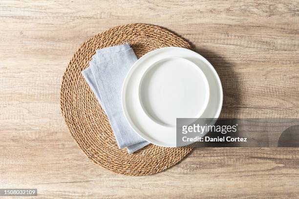 a table setting with a white plate, napkin and bowl next to a wooden background - table mat stock pictures, royalty-free photos & images