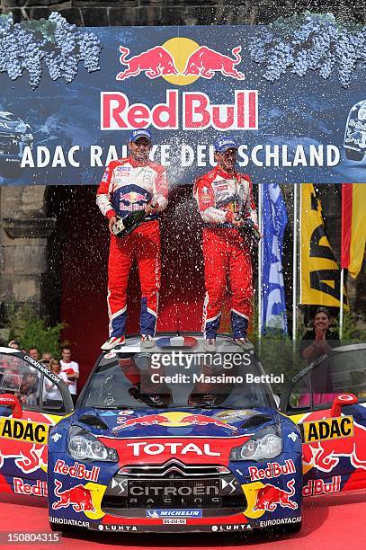 Sebastien Loeb of France and Daniel Elena of Monaco celebrate their victory during Day 3 of the WRC Rally Germany on August 26, 2012 in Trier,...