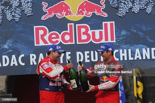 Sebastien Loeb of France and Daniel Elena of Monaco celebrate their victory during Day 3 of the WRC Rally Germany on August 26, 2012 in Trier,...