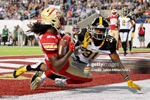 Deon Cain of the Birmingham Stallions catches a pass in the endzone to score a touchdown against Kyahva Tezino of the Pittsburgh Maulers during the...