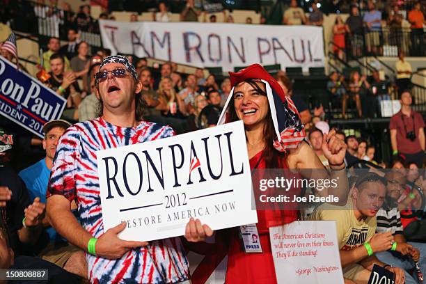 People cheer as they listen to speakers while waiting for former Republican presidential candidate U.S. Rep. Ron Paul to arrive to speak to them...