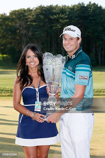 Nick Watney and his wife Amber celebrate with the trophy after NIck won the tournament following the final round of The Barclays at the Black Course...