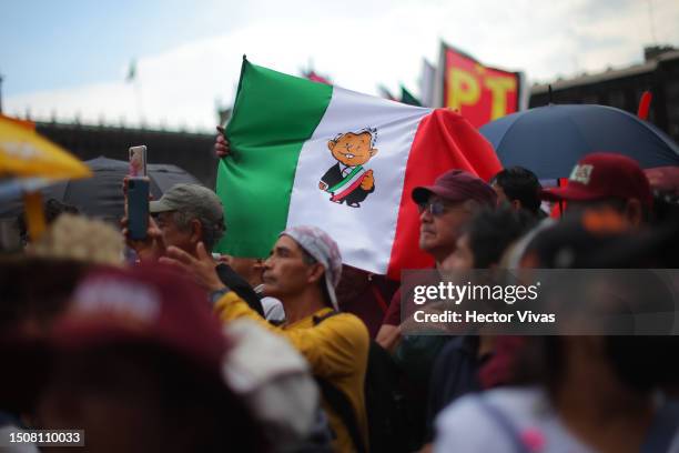 Flag of Mexico with the image of Andres Manuel Lopez Obrador is seen during the 5th year celebration of the victory in the 2018 presidential election...