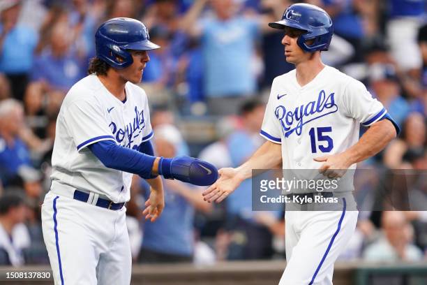 Matt Duffy of the Kansas City Royals celebrates with teammate Nick Pratto after scoring during the first inning against the Los Angeles Dodgers at...