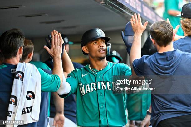 Julio Rodriguez of the Seattle Mariners celebrates with teammates in the dugout after scoring during the seventh inning against the Tampa Bay Rays at...