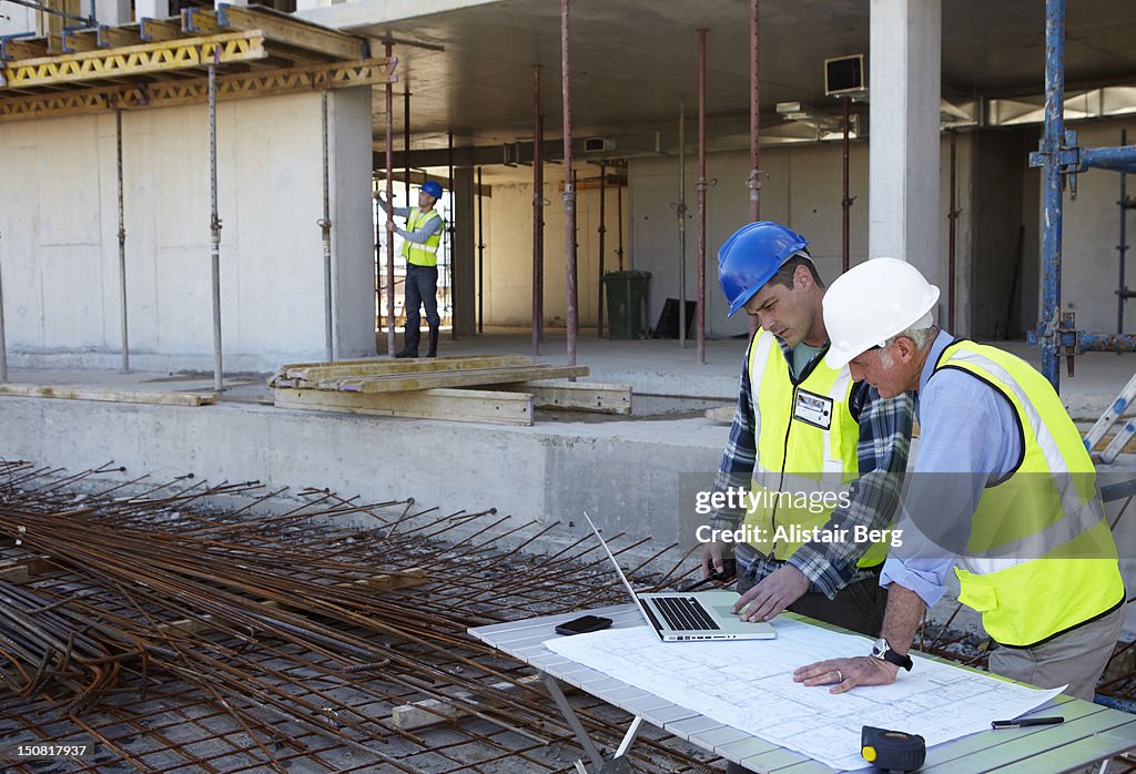 Builder and civil engineer working on site