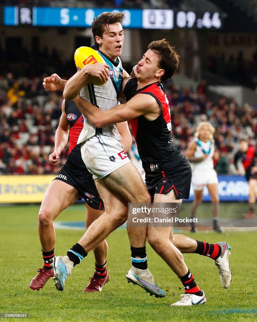 Connor Rozee Captain Connor Rozee of the Power is tackled by Nic Martin of the Bombers ...