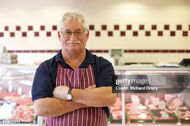 butcher in his shop - butcher portrait stock-fotos und bilder