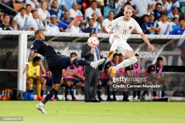 Nathaniel Mendez-Laing of Guatemala and Liam Millar of Canada attempt to kick the ball during the first half of the Concacaf Gold Cup match at Shell...