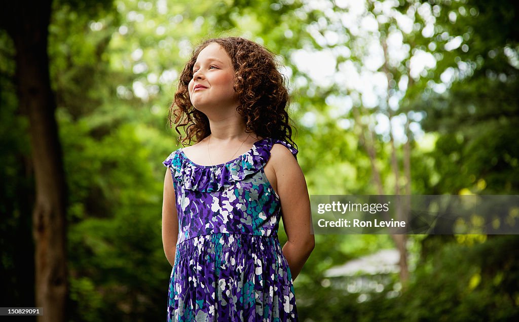 Young girl with curly hair, looking away