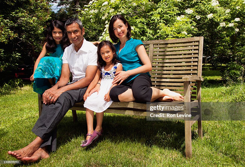 Mixed race family, portrait on bench