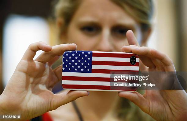 Woman takes a photograph with a phone before a "Send-Off" rally for presumptive vice presidential candidate U.S. Rep. Paul Ryan August 2012 in...