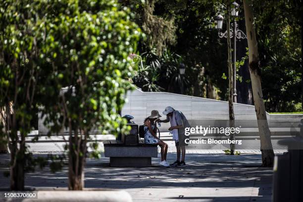 Visitors pause to drink water during high temperatures in Seville, Spain, on Wednesday, July 5, 2023. Global temperatures hit a record on Monday,...