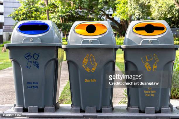 recycling bins with symbols indicating the type of waste in the park - color coded stock pictures, royalty-free photos & images