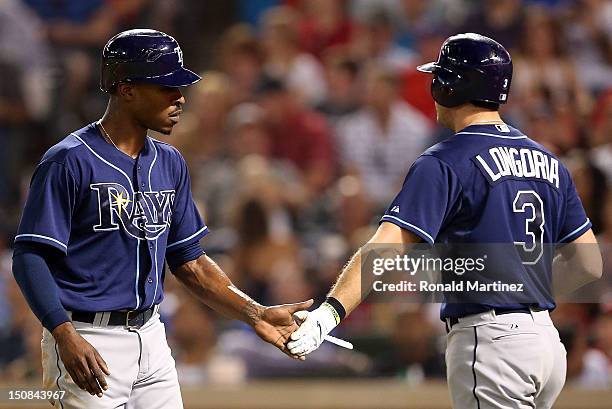 Upton celebrates a run with Evan Longoria of the Tampa Bay Rays against the Texas Rangers at Rangers Ballpark in Arlington on August 27, 2012 in...