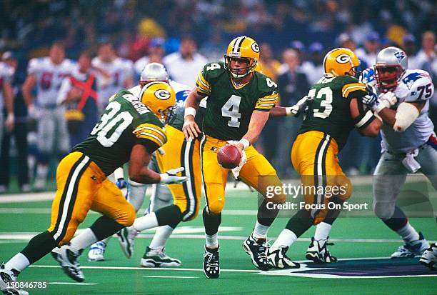 Brett Favre of the Green Bay Packers turns to hand the ball off to running back William Henderson against the New England Patriots during Super Bowl...
