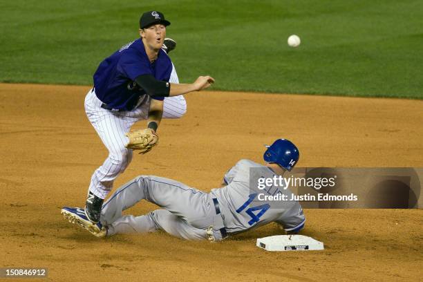 Second baseman DJ LeMahieu of the Colorado Rockies throws to first base to complete the double play as Mark Ellis of the Los Angeles Dodgers tries to...