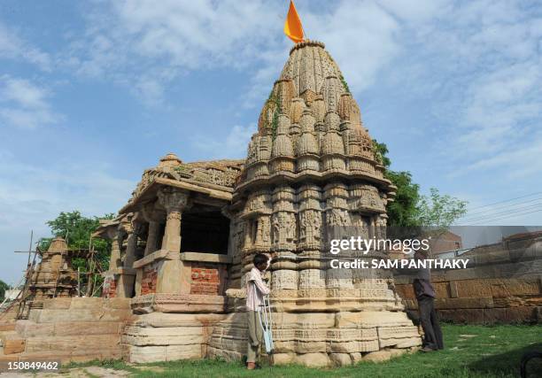 Behraram , an Indian skilled worker from the Archaeological Survey of India along with his colleague Gopalbhai, measures one of the two ancient...