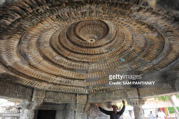 Gopalbhai, an Indian skilled worker from the Archaeological Survey of India measures one of the two ancient temples at Mansar Tank reservoir at...