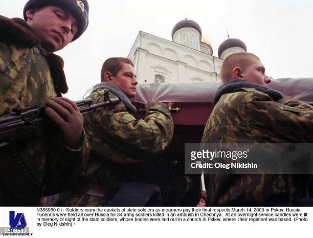 Soldiers carry the caskets of slain soldiers as mourners pay their final respects March 14, 2000 in Pskov, Russia. Funerals were held all over Russia...