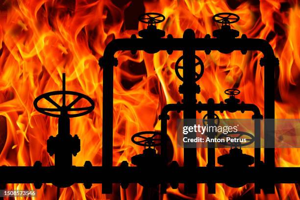 pipes and valves of the gas pipeline on the background of the flame - machine valve stock pictures, royalty-free photos & images