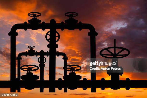 pipes and valves of the gas pipeline at sunset - gas station ストックフォトと画像
