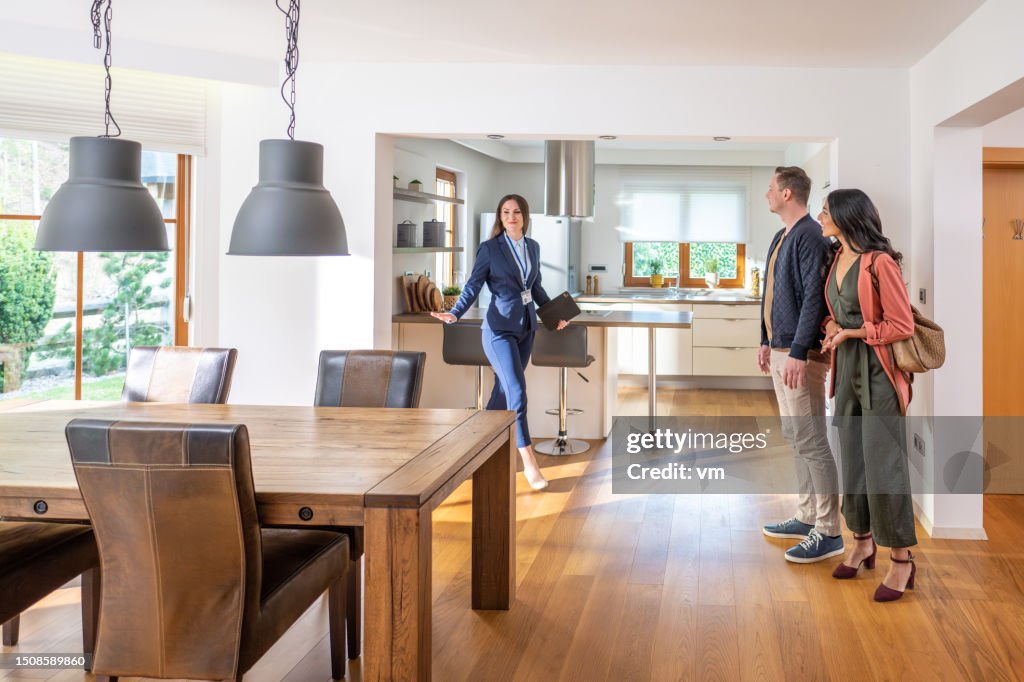 Female real estate agent showing couple apartment
