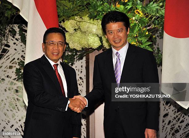 Indonesian Coordination Minister for Political, Legal, and Security Affairs, Djoko Suyanto , shakes hands with Japanese Foreign Minister Koichiro...