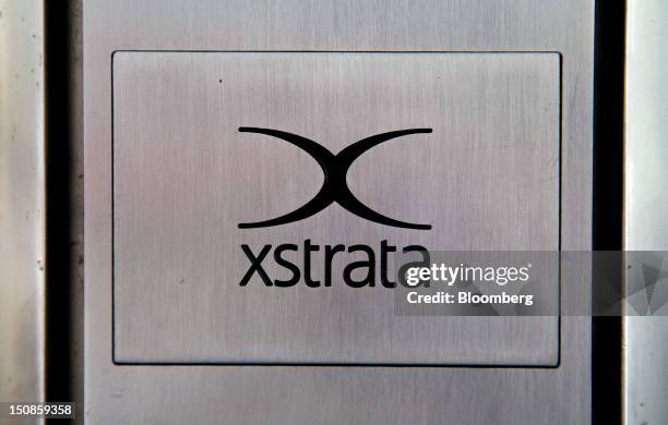 The Xstrata Plc logo sits on a plaque outside the shared building that houses the company's headquarters in Zug, Switzerland, on Friday, Aug. 24,...